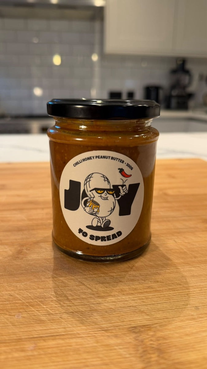 A jar of Joy to Spread on a wooden board in Aiden's kitchen